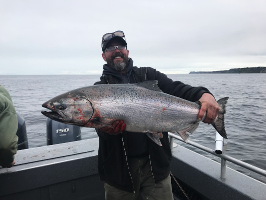 Fisherman holding Alaska king salmon