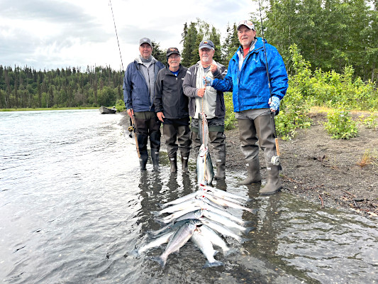 Group of fishermen with a stringer of red salmon on the Kasilof River Alaska