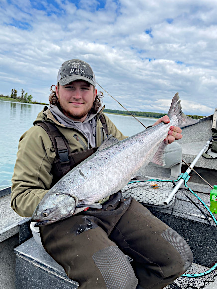Fisherman on the Kasilof River holding a salmon